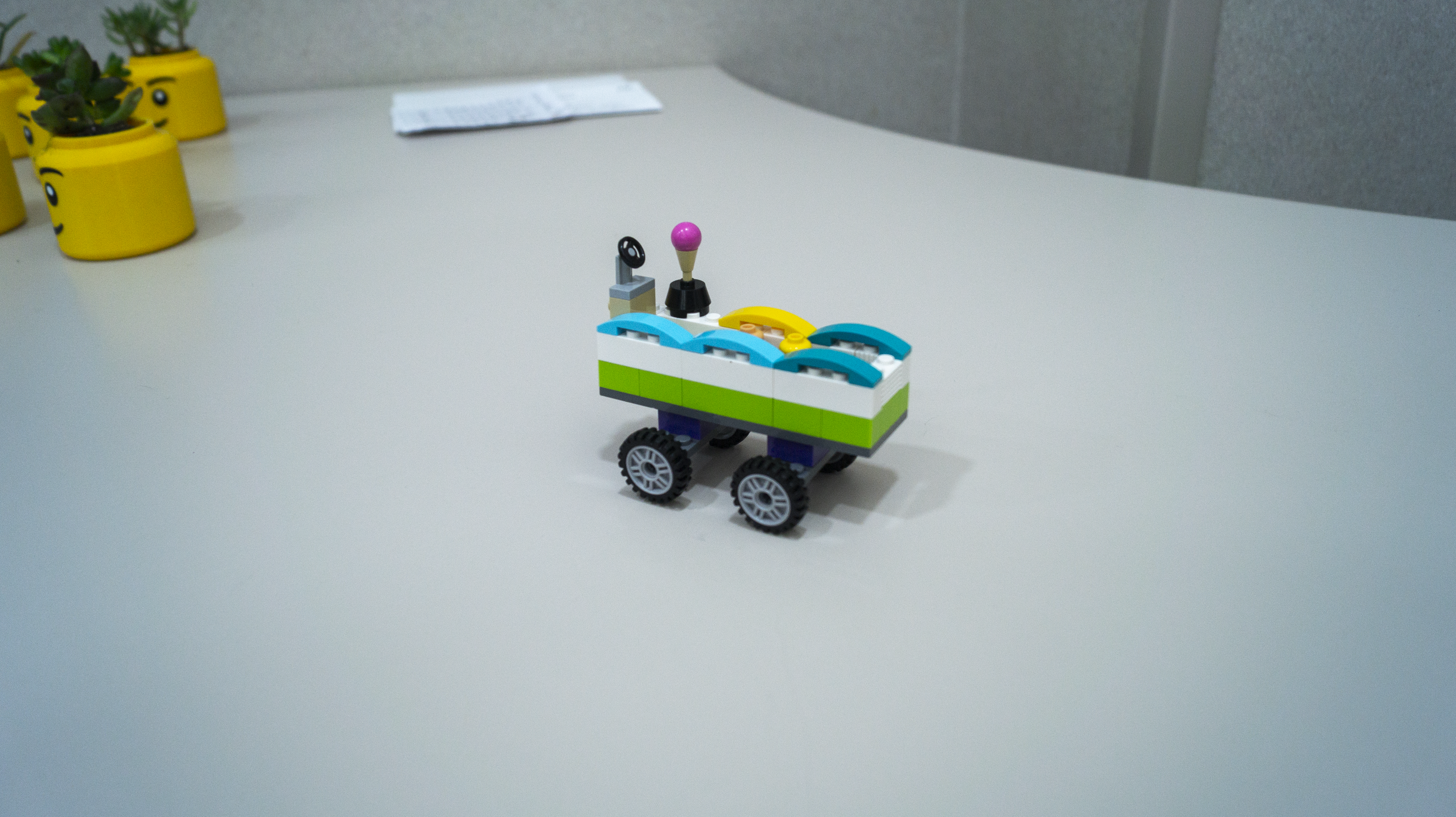 A small Lego vehicle with waves on top.