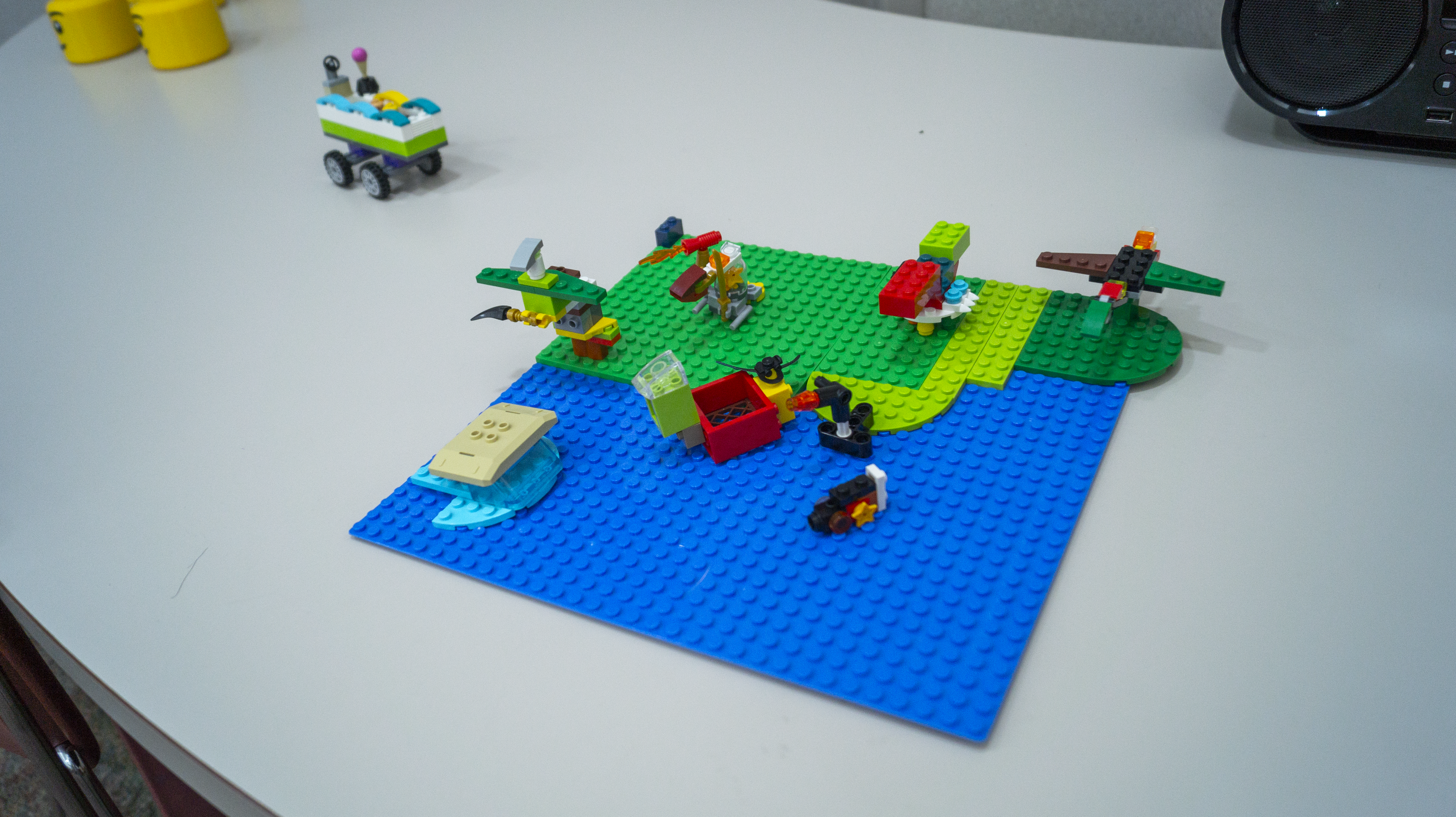 A Lego creation that looks like a lake and green beach