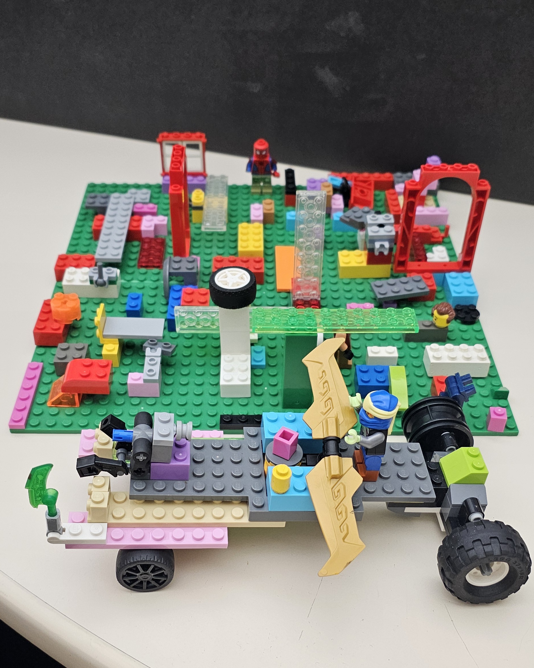 Lego creation with a car and a mixed up city.