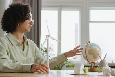 GreenFILE resource image showing woman looking at a small globe