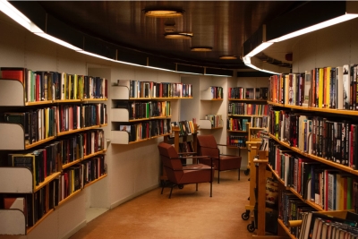 Library, Information Science & Technology Abstracts resource image showing a dim interior of a library