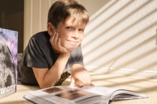 Britannica School - Elementary resource image showing a young boy looking through a book