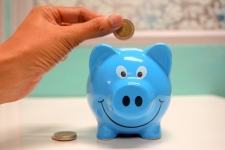 putting money in a piggy bank