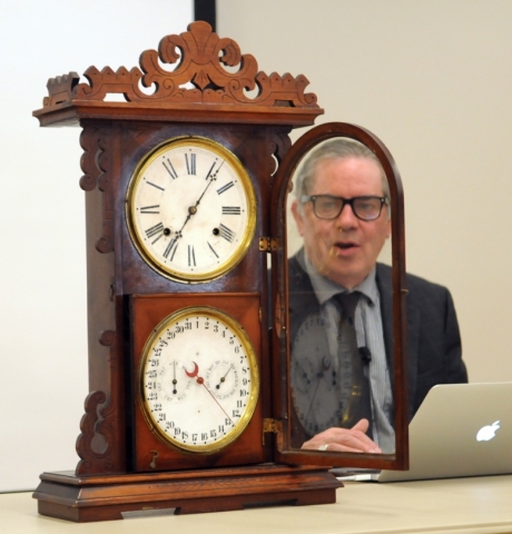 Appraiser Mark Moran evaluating an antique clock. 