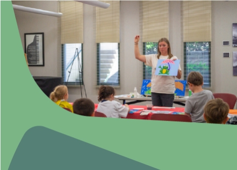 An instructor teaching kids to paint