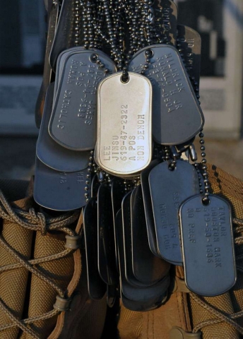 Dog tags from 3rd Brigade Combat Team, 25th Infantry Division, Task Force Bronco’s fallen heroes hang from a pair of combat boots as part of a sunrise memorial held to honor those lost over the last year’s deployment on Forward Operating Base Fenty, Jan. 28. (Photo courtesy of Task Force Bronco, Public Affairs)
